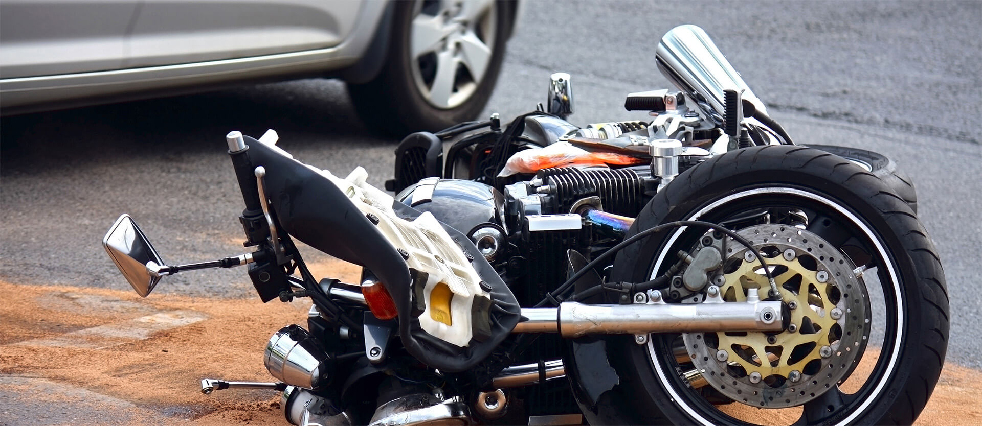 a damaged motorcycle on the road after an accident