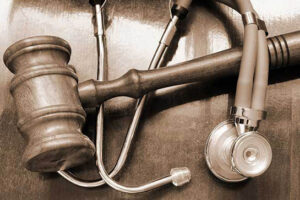 judge's gavel underneath a doctor's stethoscope