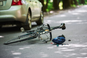a bicycle helmet and bicycle in the middle of the road from an accident.