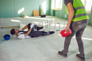 injured workers on a construction site suffering workplace injuries and should call workers compensation attorneys