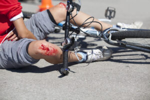 bicyclist on ground with a bloody knee injury after a bicycle accident in Las Vegas